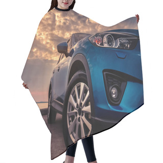 Personality  Blue SUV Car With Sport And Modern Design Parked On Concrete Road By The Sea At Sunset In The Evening. Hybrid And Electric Car Technology Concept. Automotive Industry. Headlamp Hair Cutting Cape