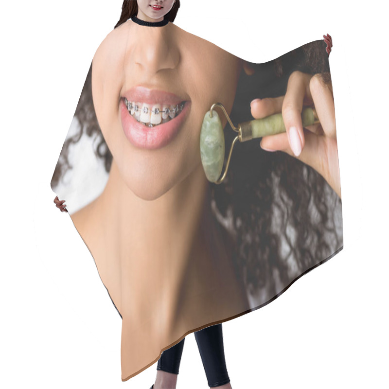 Personality  Cropped View Of Smiling African American Girl With Dental Braces Using Natural Massage Roller, Isolated On Grey  Hair Cutting Cape