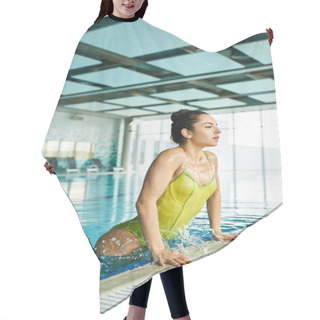 Personality  A Stunning Brunette Woman In A Vibrant Yellow Bathing Suit Gracefully Swims In An Indoor Pool At A Luxurious Spa. Hair Cutting Cape