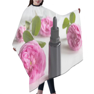 Personality  A Bottle Of Rose Essential Oil With Rose Flowers Hair Cutting Cape