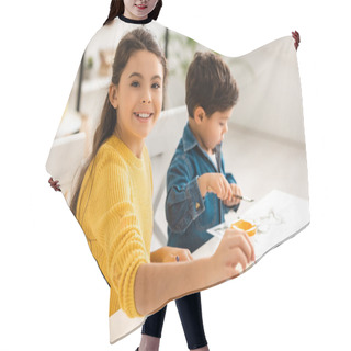 Personality  Cheerful Sister Looking At Camera While Sitting At Table And Drawing Together With Brother Hair Cutting Cape