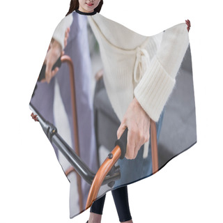 Personality  Cropped View Of Social Worker Supporting Aged Woman Walking With Medical Walkers Hair Cutting Cape