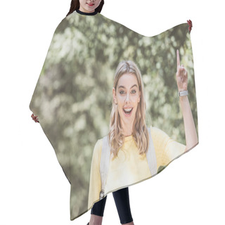 Personality  Portrait Of Young Cheerful Woman With Backpack Pointing Up And Looking At Camera In Park Hair Cutting Cape