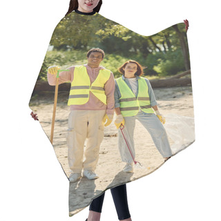 Personality  A Socially Active Diverse Couple, Adorned In Safety Vests And Gloves, Stands United On The Beach. Hair Cutting Cape