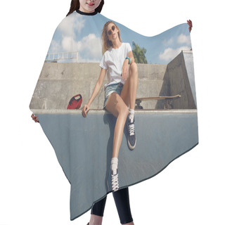 Personality  Summer. Skater Girl Sitting On Concrete Skate Ramp At Skatepark. Female Teenager In Casual Outfit With Skateboard. Urban Sport As Lifestyle For Active Teens In City. Hair Cutting Cape