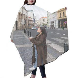 Personality  Pretty Traveler In Coat Holding Paper Cup And Looking Away On Urban Street In Prague  Hair Cutting Cape