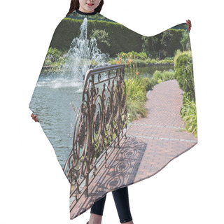 Personality  Selective Focus Of Metallic Fence On Bridge Near Lake With Fountain  Hair Cutting Cape