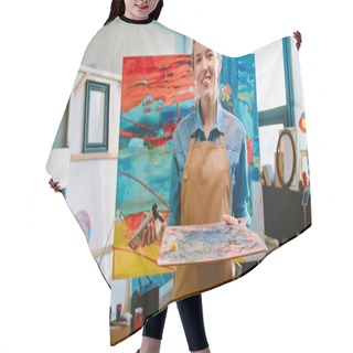 Personality  Portrait Of Cheerful Caucasian Young Pretty Happy Woman Artist Stands In Workshop Alone Smiling And Pouring Paint On Palette Before Painting On Canva. Modern Artwork, Painter At Work, Hobby Concept Hair Cutting Cape