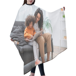 Personality  African American Mother Using Laptop Near Child On Couch In Living Room  Hair Cutting Cape