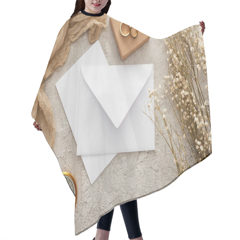 Personality  top view of envelope near beige sackcloth, golden compass and wedding rings on textured surface hair cutting cape