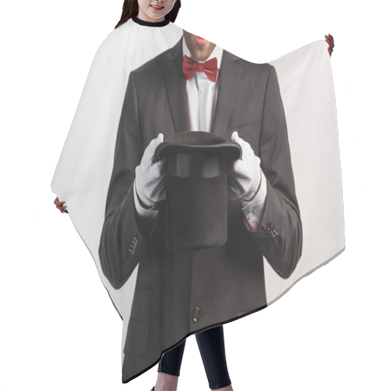 Personality  cropped view of shocked magician holding hat, isolated on grey hair cutting cape