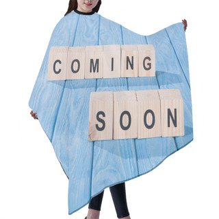 Personality  Close Up View Of Arranged Wooden Blocks Into Coming Soon Phrase On Blue Wooden Surface  Hair Cutting Cape