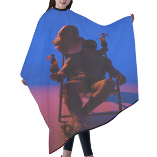 Personality  Silhouette Of Woman Leaning On Chair With Man And Holding Cocktails On Blue Background In Dark Light Hair Cutting Cape