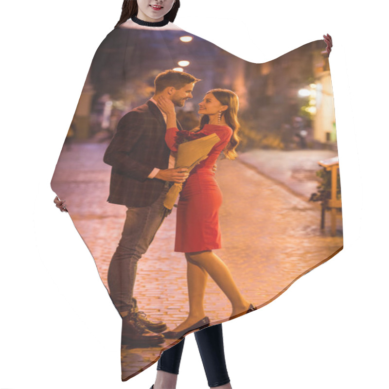 Personality  happy, elegant girl hugging boyfriend holding bouquet of red roses on night street hair cutting cape