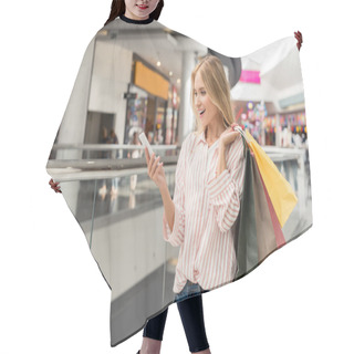 Personality  Young Smiling Female Shopper With Paper Bags Using Smartphone At Shopping Mall  Hair Cutting Cape