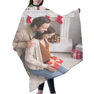 Personality  Happy Man Hugging Shoulders Of Pregnant Wife Sitting On Floor Near Fireplace With Christmas Decoration Hair Cutting Cape