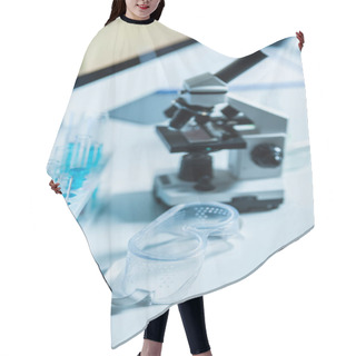 Personality  Goggles Near Blurred Test Tubes And Microscope In Laboratory Hair Cutting Cape