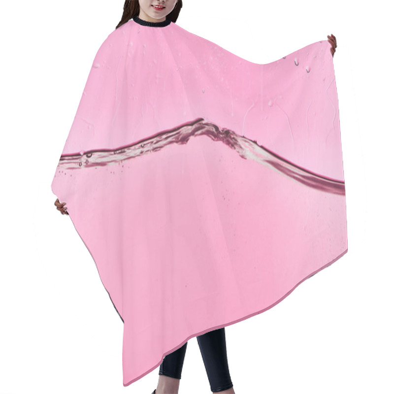 Personality  wavy clear fresh water on pink background with flowing drops hair cutting cape