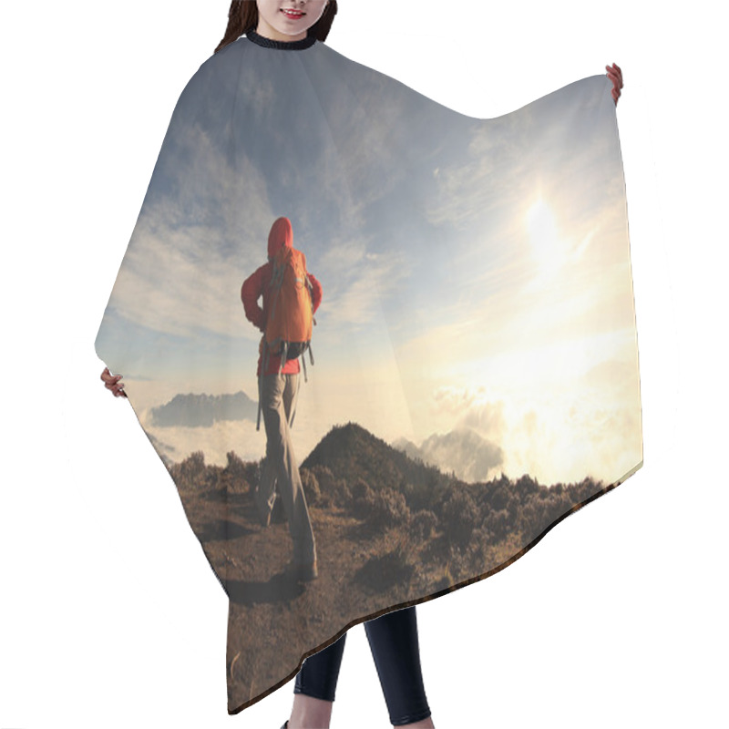 Personality  woman hiking on mountain peak hair cutting cape