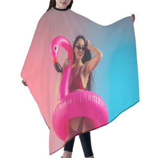 Personality  Fashion Portrait Of Young Fit And Sportive Woman With Rubber Flamingo In Stylish Red Swimwear On Gradient Background. Perfect Body Ready For Summertime. Hair Cutting Cape