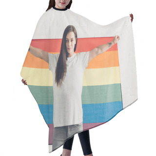 Personality  Confident Transgender Woman Holding Pride Flag In Front Of White Brick Wall Hair Cutting Cape