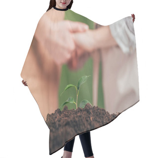 Personality  Selective Focus Of Young Green Plant, And Man Holding Kid Hands On Blurred Background, Earth Day Concept Hair Cutting Cape