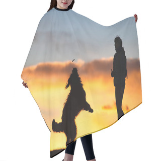 Personality  Big Dog Jumping To Take A Biscuit From A Woman Silhouette With Background At Colorful Sunset . Hair Cutting Cape