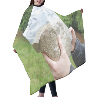 Personality  Woman Is Holding A Bag Of Grass Seeds In Her Hands. Hair Cutting Cape