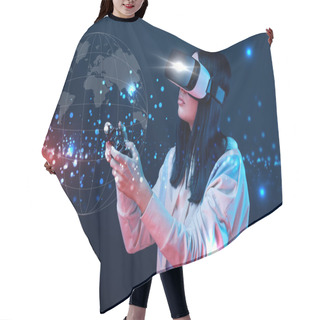 Personality  KYIV, UKRAINE - APRIL 5, 2019: Young Woman In Virtual Reality Headset Using Joystick On Dark Background With Globe Illustration Hair Cutting Cape