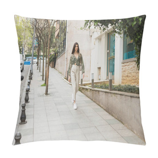 Personality  Young Woman With Long Hair In Beige Pants, Cropped Blouse And Handbag With Chain Strap Walking Near Modern Building, Parked Cars And Green Trees On Urban Street, Tourist In Istanbul Pillow Covers