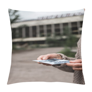 Personality  PRIPYAT, UKRAINE - AUGUST 15, 2019: Cropped View Of Senior Woman Holding Black And White Photo Near Building Pillow Covers