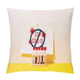 Personality  Paper With Stop Covid-19 Lettering Near Test Tubes With Coronavirus Test On White And Yellow Pillow Covers