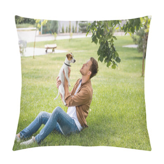 Personality  Young Man In Jeans And Brown Shirt Sitting On Green Grass And Holding Jack Russell Terrier Dog Pillow Covers