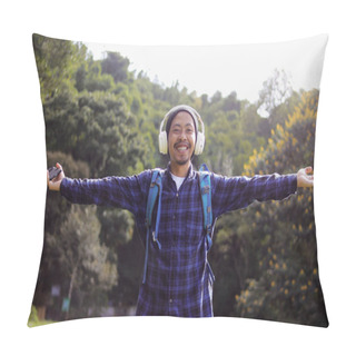 Personality  Young Asian Man In A Casual Outfit, Sporting A Beanie, Plaid Shirt, Backpack, And Headphones, Stretches His Arms Wide With A Smile, Seemingly Enjoying The Fresh Morning Air On A Nature Walk. Pillow Covers