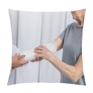 Personality  Cropped View Of Senior Woman With Plaster Bandage On Arm Standing Near African American Doctor  Pillow Covers