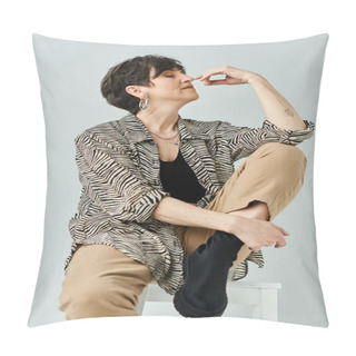 Personality  A Stylish Middle-aged Woman With Short Hair Sits Gracefully Atop A Pristine White Stool In A Chic Studio Setting. Pillow Covers