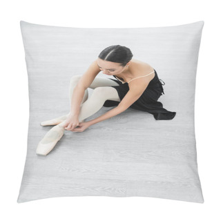 Personality  Young Ballerina Adjusting Pointe Shoe While Sitting On Floor In Studio Pillow Covers