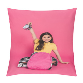 Personality  Positive And Brunette Schoolgirl Sitting With Backpack, Holding Vintage Alarm Clock On Pink Pillow Covers