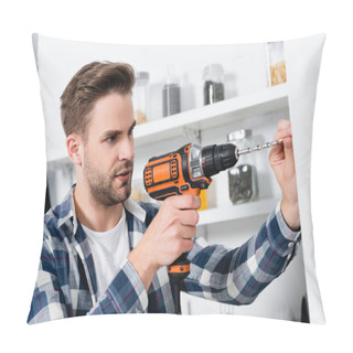 Personality  Focused Young Man Using Drill On Blurred Background In Kitchen Pillow Covers
