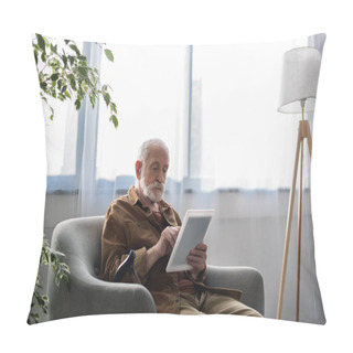 Personality  Concentrated Senior Man Using Digital Tablet While Sitting In Armchair Pillow Covers