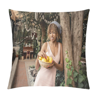 Personality  Cheerful African American Woman With Braces In Headscarf And Summer Dress Looking At Fresh Lemons In Basket And Standing Near Trees In Indoor Garden, Stylish Woman With Tropical Plants At Backdrop Pillow Covers