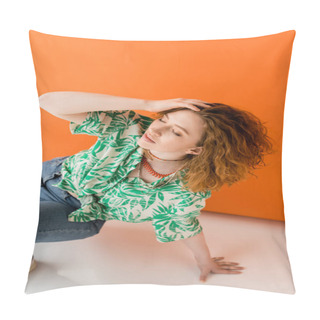 Personality  Stylish Young Red Haired Woman In Jeans And Blouse With Floral Pattern Touching Head And Closing Eyes While Posing On Orange Background, Trendy Casual Summer Outfit Concept, Youth Culture Pillow Covers
