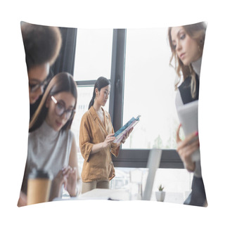 Personality  Young Asian Businesswoman Reading Magazine While Colleagues Working On Blurred Foreground Pillow Covers