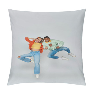 Personality  Excited Interracial Couple In Casual Attire Jumping And Looking At Camera On Grey Backdrop, Fun Pillow Covers