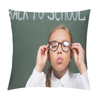 Personality  Selective Focus Of Cute Schoolgirl Touching Eyeglasses And Blowing Air Kiss Near Chalkboard With Back To School Lettering Pillow Covers