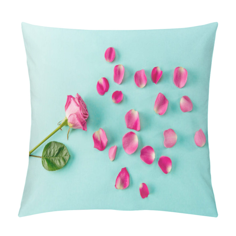 Personality  Top view of beautiful pink rose flower with petals on blue pillow covers