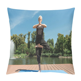 Personality  Woman Practicing Yoga In Tree Pose (Vrksasana) On Yoga Mat Near River In Park Pillow Covers