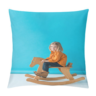 Personality  Blonde And Cute Kid Sitting On Rocking Horse And Looking At Camera On Blue Background  Pillow Covers