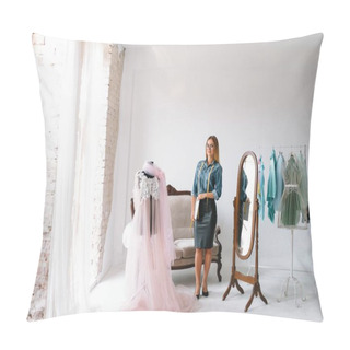 Personality  Smiling Fashion Designer Looking At Camera At Workplace, Dressmaker, Needlewoman Or Tailor Shop Owner Sitting At Desk With Color Swatches Pantone And Embroidery Design Sketches On The Wall, Portrait Pillow Covers