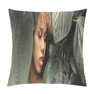 Personality  Modern Young African American Woman With Makeup Looking At Green Leaves While Standing Near Plants In Indoor Garden, Stylish Woman Enjoying Lush Tropical Surroundings, Banner  Pillow Covers